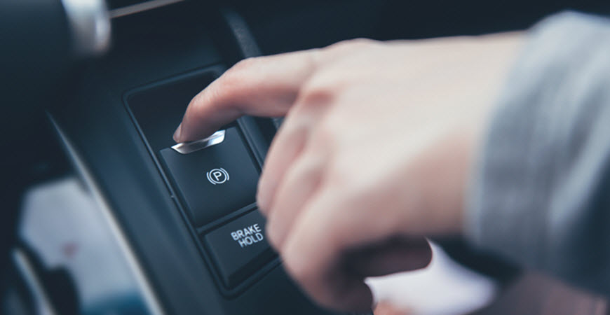 Land Rover Driver Pressing Parking Brake